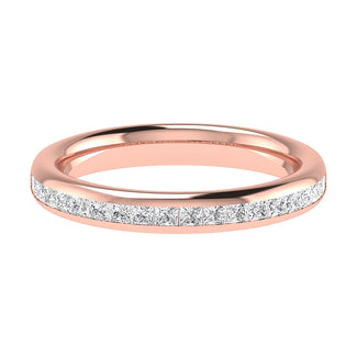 A delicate rose gold Channel Set Princess Cut ring by Holts Gems, featuring a row of sparkling princess cut diamonds set along the top half of the band, displayed on a white background.