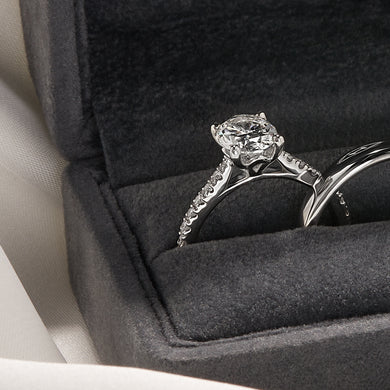 A diamond engagement ring and wedding band in a ring box