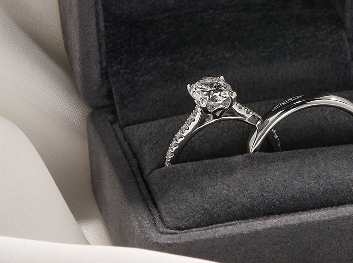 A diamond engagement ring and wedding band in a ring box