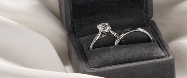 A diamond engagement ring and wedding band in a ring box